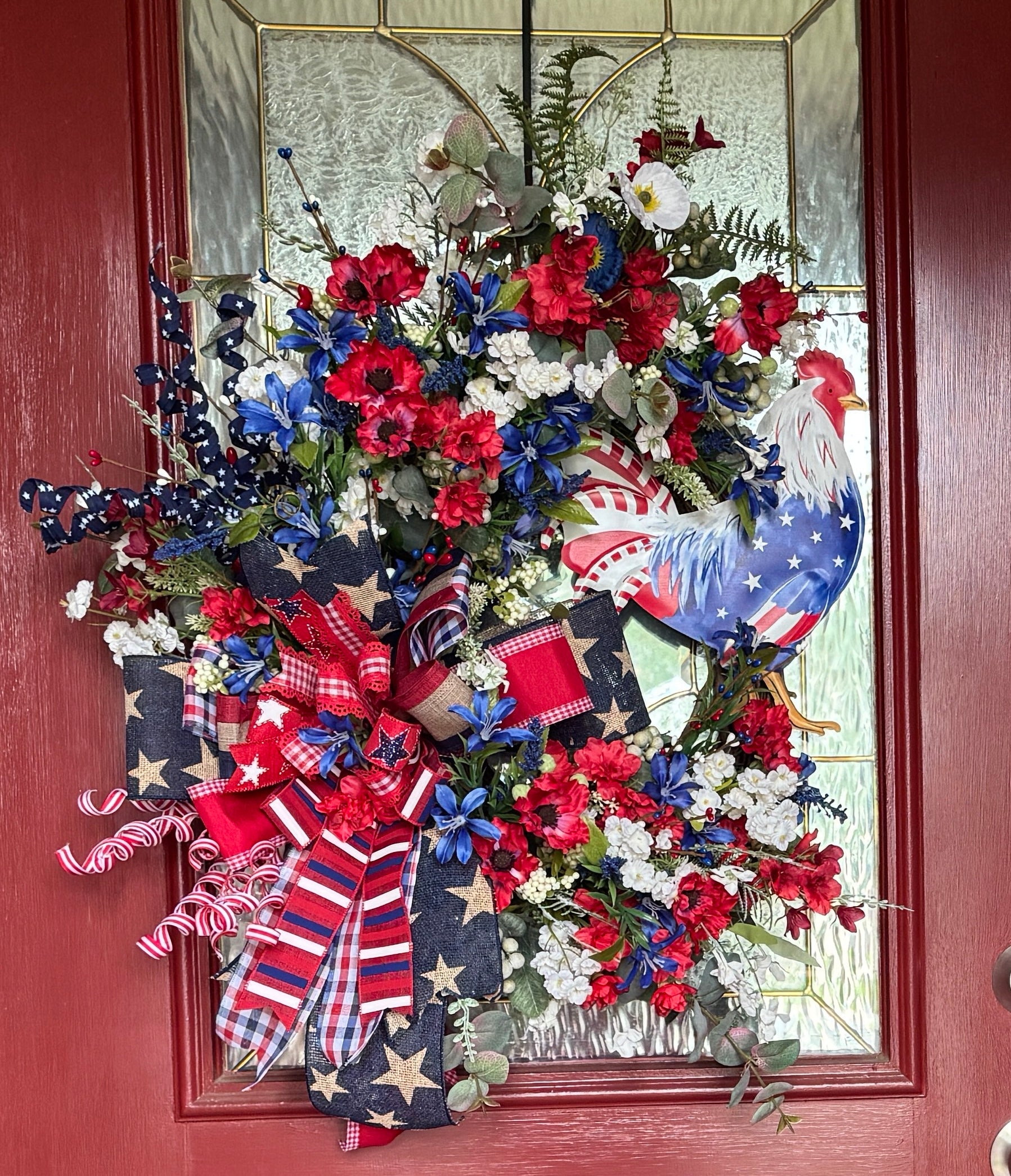 Large grapevine wreath with red, white , and blue flowers and ribbon, with a red, white , and bloe July 4th Rooster embelishment