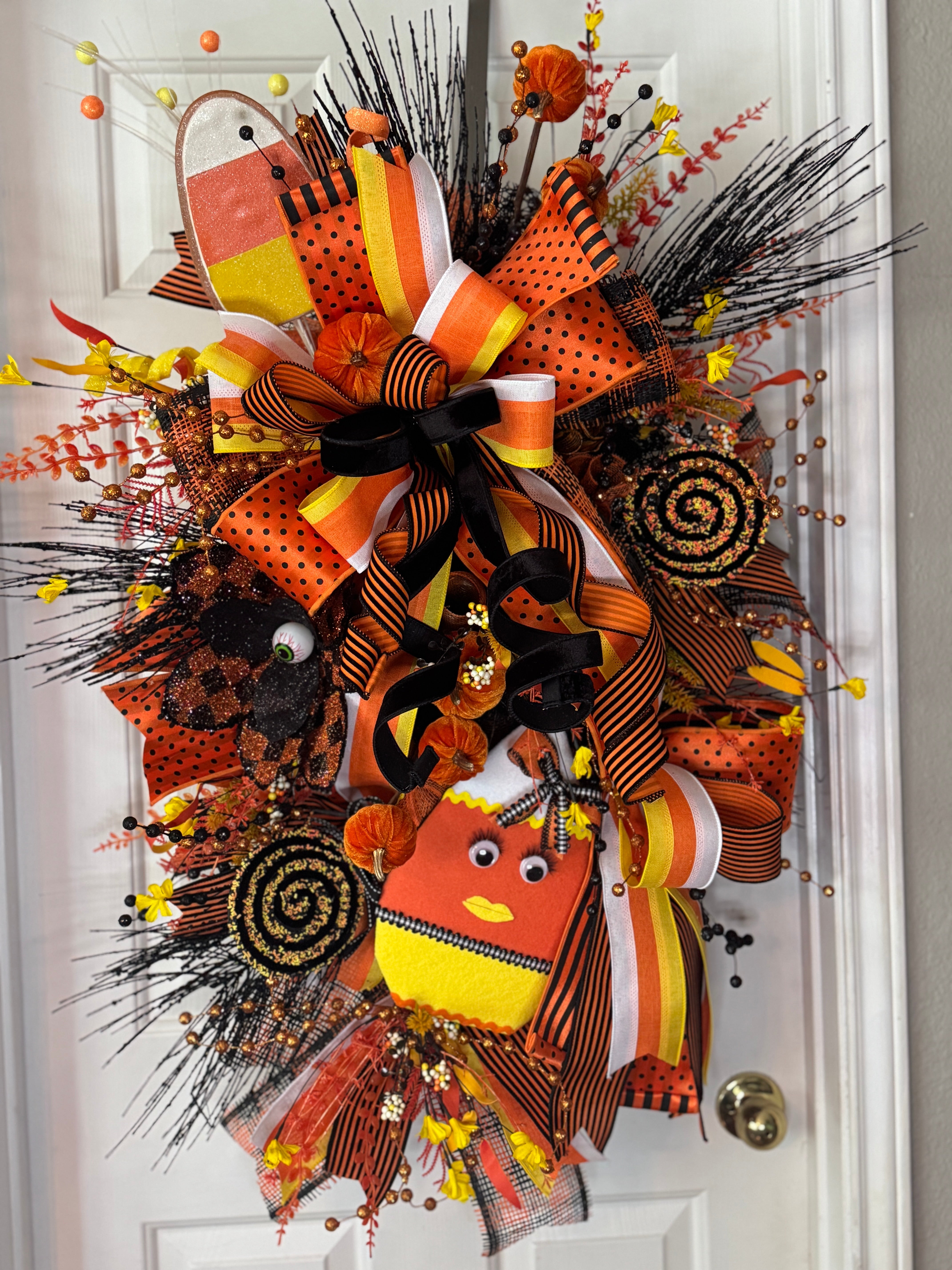 Beutiful large candy corn themed Teardrop wreath in orange, yellow , white, and black with matching embelishments and ribbon
